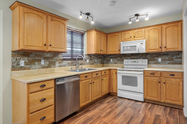 kitchen featuring decorative backsplash, white appliances, sink, and dark wood-type flooring