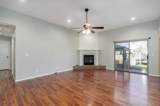 unfurnished living room featuring ceiling fan, dark hardwood / wood-style flooring, and a fireplace