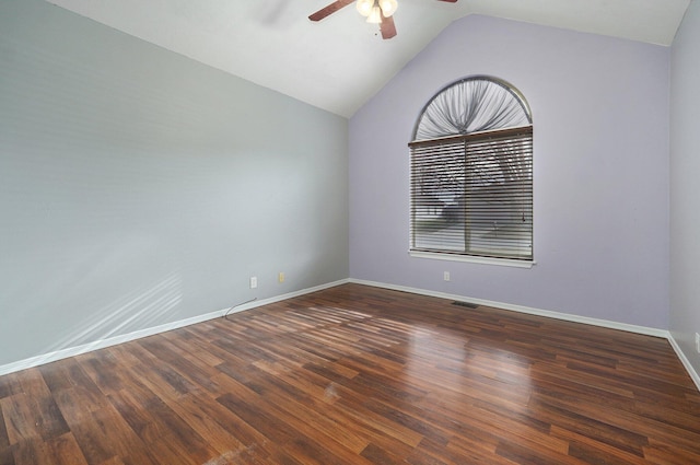 spare room with dark hardwood / wood-style floors, ceiling fan, and lofted ceiling