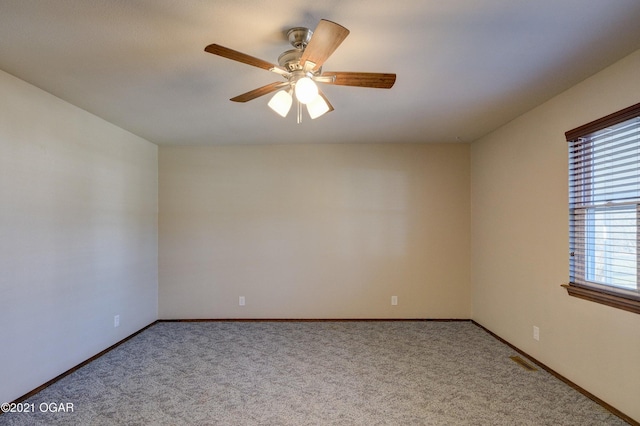 unfurnished room with ceiling fan and light carpet