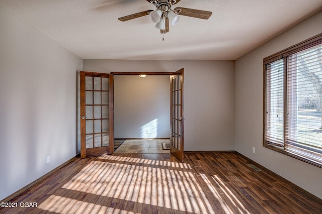 spare room featuring a textured ceiling, ceiling fan, french doors, and dark hardwood / wood-style floors