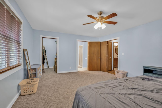 bedroom featuring ceiling fan, ensuite bathroom, and light carpet