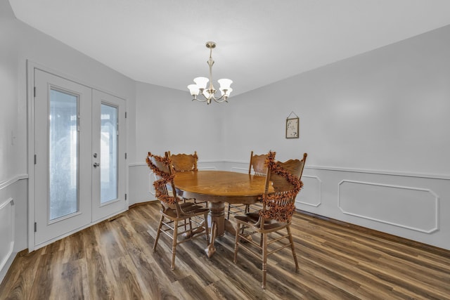 dining space featuring a chandelier, french doors, and dark hardwood / wood-style floors