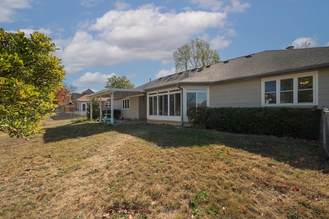 back of property featuring a lawn