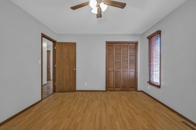 unfurnished bedroom with multiple windows, ceiling fan, a closet, and light hardwood / wood-style floors