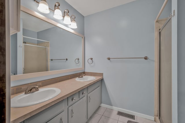 bathroom with tile patterned flooring, vanity, and an enclosed shower