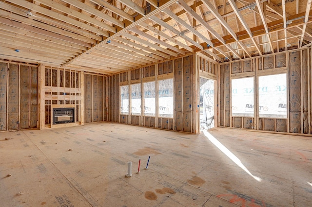 unfurnished living room featuring heating unit