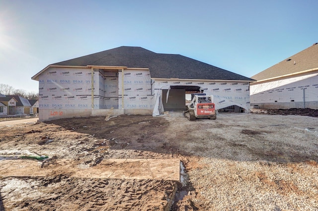 exterior space with a shingled roof