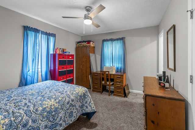 carpeted bedroom featuring a textured ceiling and ceiling fan