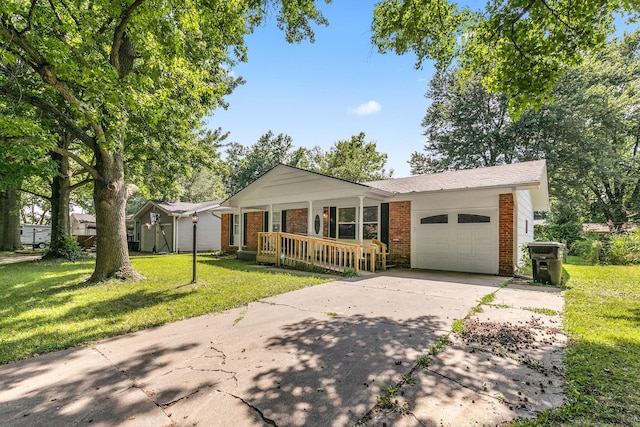 single story home featuring a garage, covered porch, and a front yard