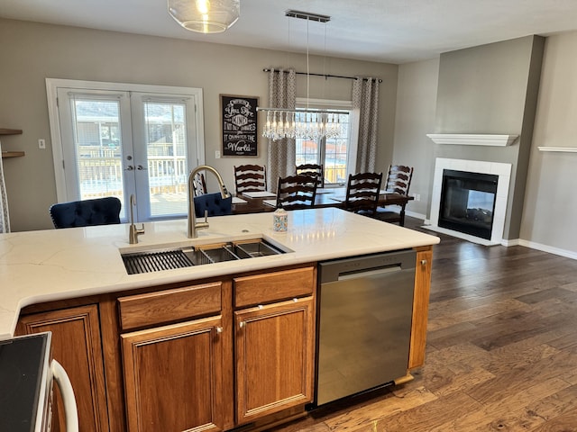 kitchen featuring stainless steel dishwasher, decorative light fixtures, a healthy amount of sunlight, and sink