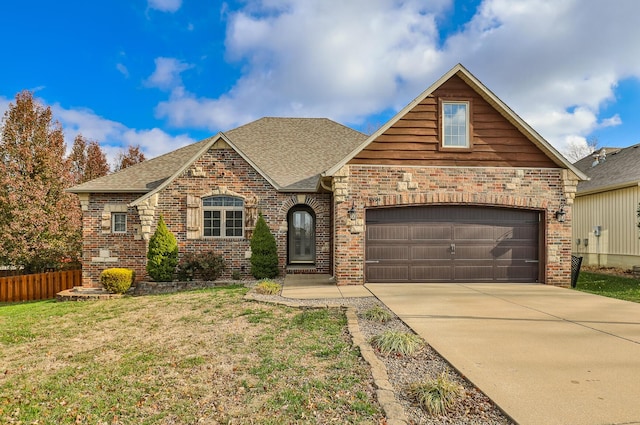 view of front of house with a garage and a front yard