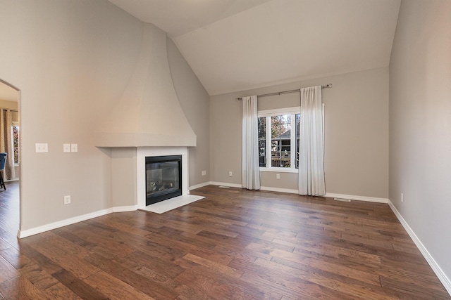 unfurnished living room with dark hardwood / wood-style floors, lofted ceiling, and a fireplace