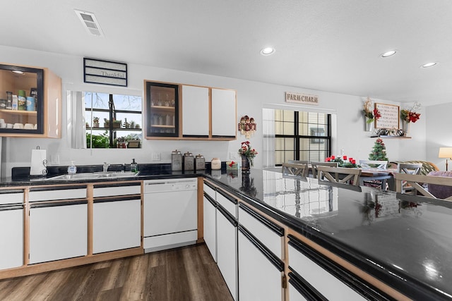 kitchen featuring dishwasher, white cabinets, dark wood-type flooring, and sink