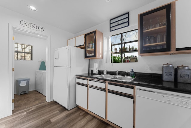 kitchen featuring white appliances, sink, white cabinets, independent washer and dryer, and dark hardwood / wood-style floors