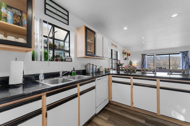 kitchen featuring dishwasher, dark wood-type flooring, sink, a textured ceiling, and white cabinetry