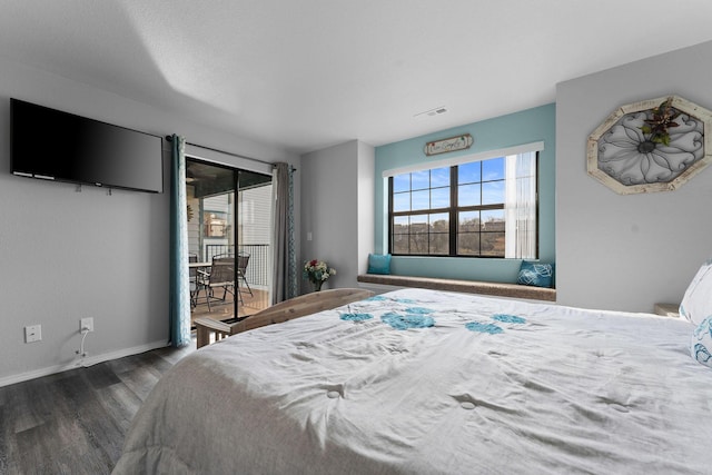 bedroom featuring access to outside and dark hardwood / wood-style flooring