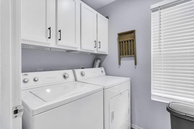 washroom with cabinets and separate washer and dryer