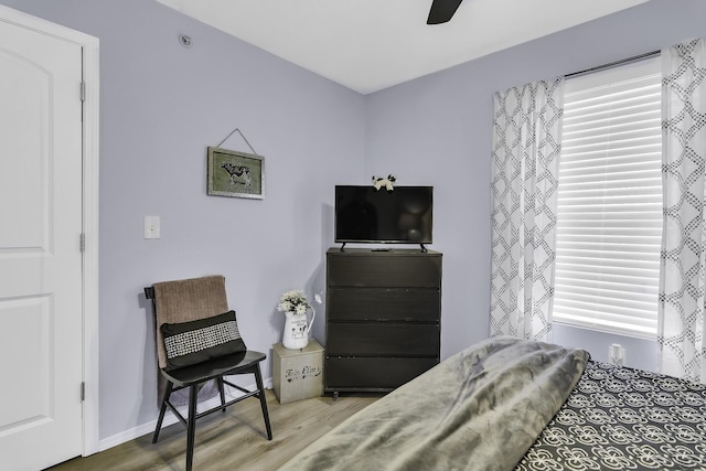 bedroom with light hardwood / wood-style floors and ceiling fan