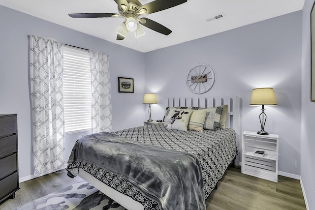 bedroom featuring ceiling fan and dark hardwood / wood-style flooring