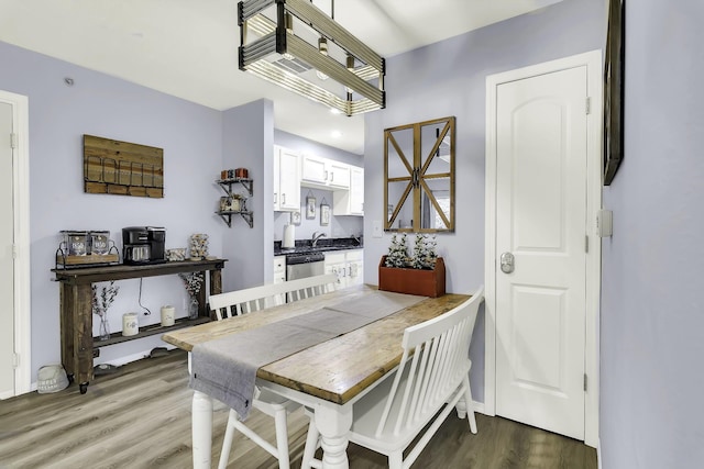 dining room featuring hardwood / wood-style floors and sink