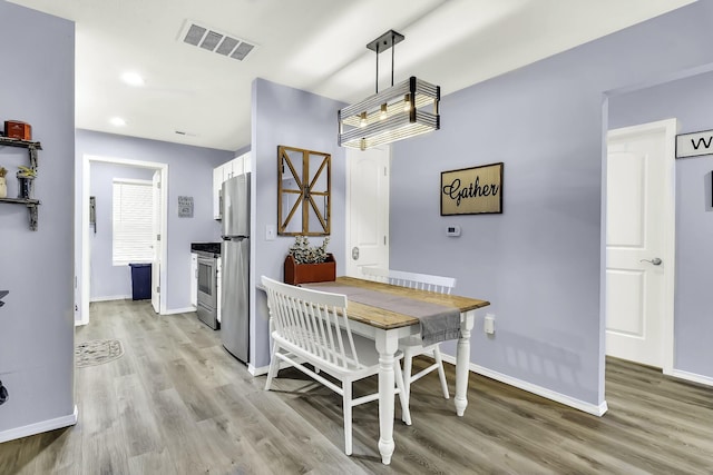 dining space featuring light wood-type flooring