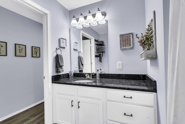 bathroom with vanity and wood-type flooring