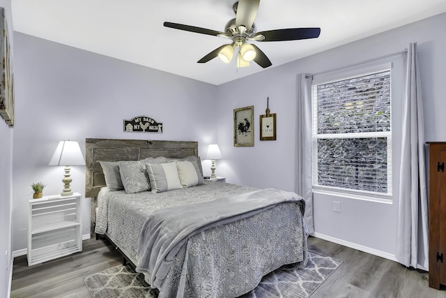 bedroom featuring ceiling fan and dark hardwood / wood-style flooring