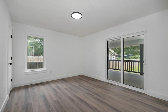 empty room with dark wood-type flooring