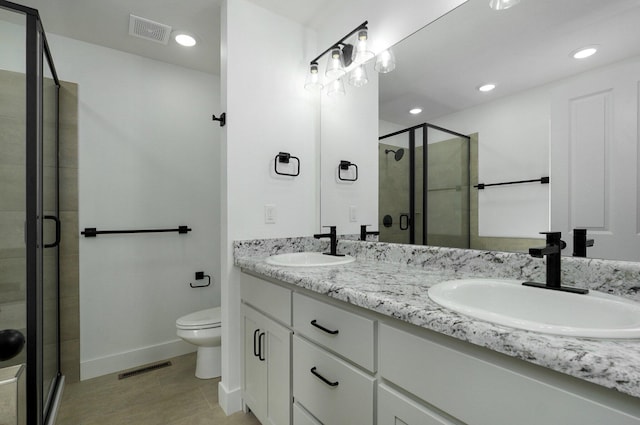 bathroom with tile patterned floors, vanity, toilet, and walk in shower