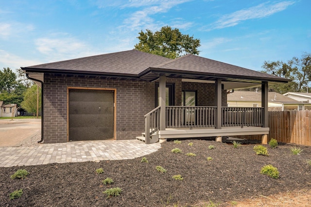 view of front of home with a porch and a garage