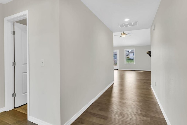 corridor with dark hardwood / wood-style flooring