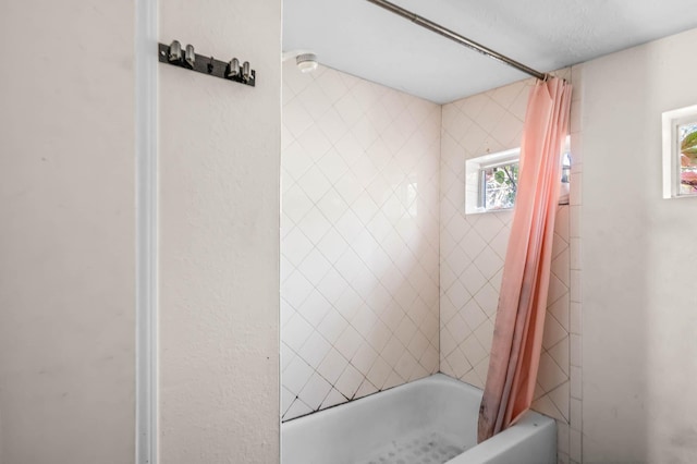 bathroom with shower / bathtub combination with curtain