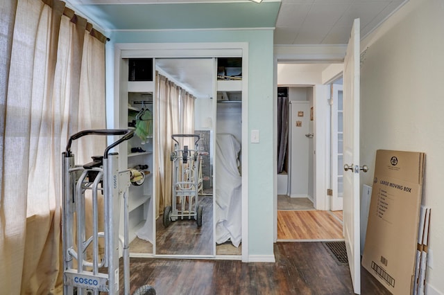 interior space with crown molding and dark hardwood / wood-style floors