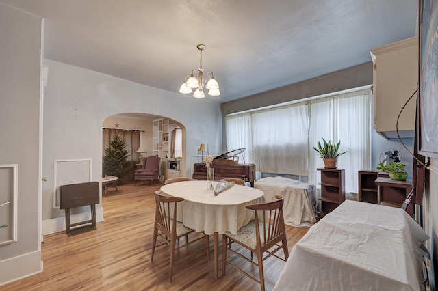 dining area featuring light hardwood / wood-style flooring and a chandelier