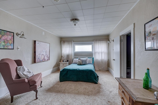 bedroom with crown molding and light colored carpet