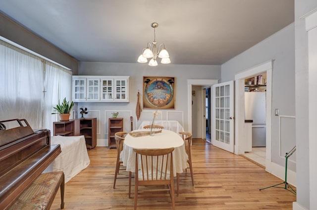 dining room featuring light hardwood / wood-style floors and a notable chandelier