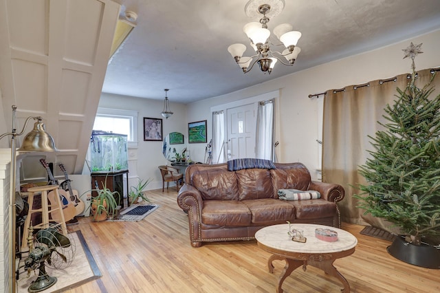 living room with hardwood / wood-style floors and an inviting chandelier