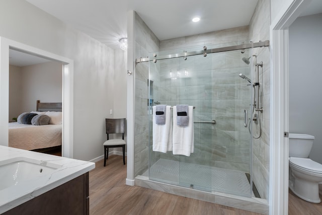 bathroom with vanity, toilet, wood-type flooring, and walk in shower