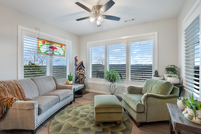 living area with hardwood / wood-style flooring and ceiling fan