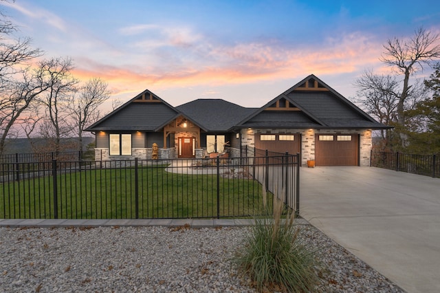 view of front of house with a garage and a lawn