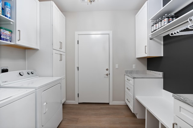 laundry room featuring washing machine and dryer, cabinets, and light hardwood / wood-style floors