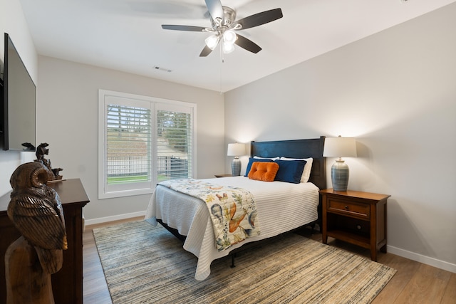 bedroom with hardwood / wood-style floors and ceiling fan