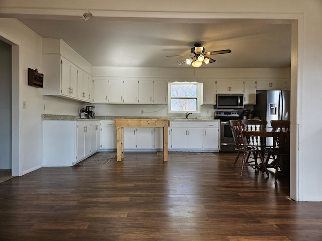 21525 State Highway P, Ava, MO 65608 - kitchen featuring appliances with stainless steel finishes, dark wood-style flooring, ceiling fan, and white cabinets