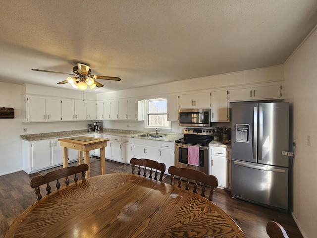 21525 State Highway P, Ava, MO 65608 - kitchen with appliances with stainless steel finishes, dark wood-style flooring, light countertops, white cabinetry, and a textured ceiling