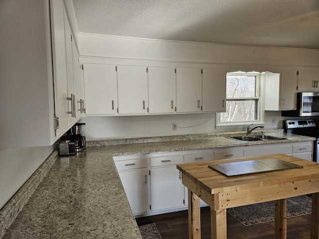 21525 State Highway P, Ava, MO 65608 - kitchen featuring appliances with stainless steel finishes, white cabinetry, and a textured ceiling