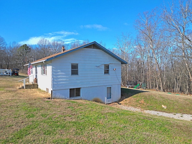 view of side of property with a yard