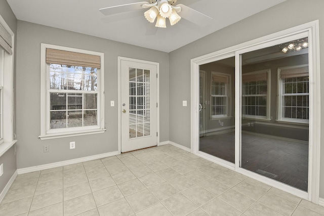 unfurnished sunroom with ceiling fan