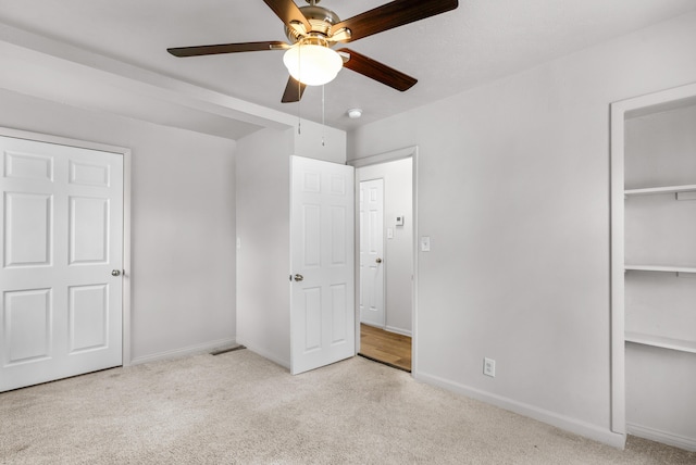 unfurnished bedroom with ceiling fan and light carpet