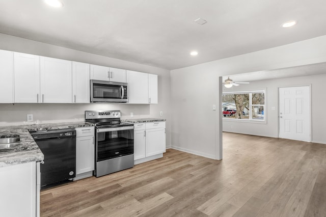 kitchen featuring ceiling fan, stainless steel appliances, light stone counters, light hardwood / wood-style floors, and white cabinets